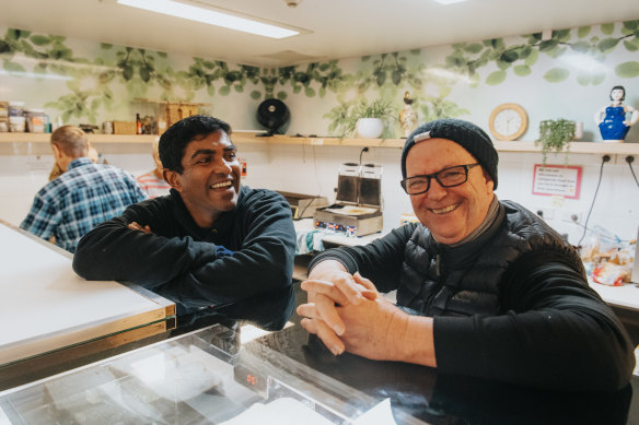 Pastor Jon Owen, left, and Rohan Cannon serving meals at Wayside Chapel on Friday.