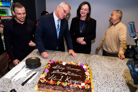 Prime Minister Scott Morrison appraises his ‘Strong economy, strong future’ cake at Abla’s Pastries in Granville in the seat of Parramatta on Thursday.