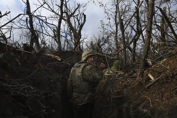 Soldiers with the 68th brigade move along the trenches at a forward infantry position in the Donbas oblast. 