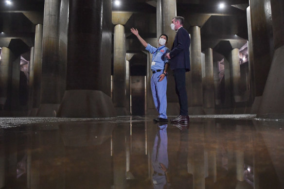 NSW Premier Dominic Perrottet (right) speaks to a technician inside the pressure-adjusting water tank whilst touring the Metropolitan Outer Area Underground Discharge Channel in Ryukyukan, during his trade mission trip in Tokyo.