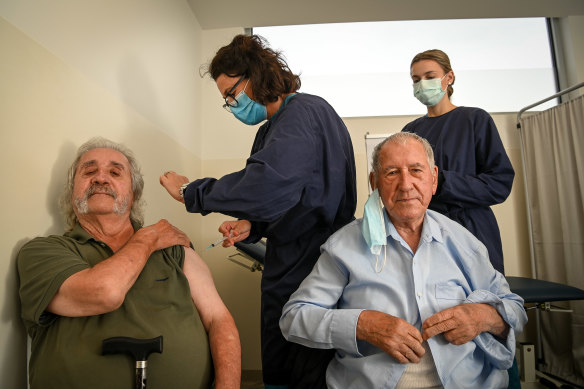 John Manolakakis and his father, Jim, receive a coronavirus vaccine at Altona North Respiratory Clinic on Monday.