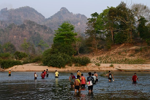 The group this masthead met in Thailand wade back to Myanmar. 