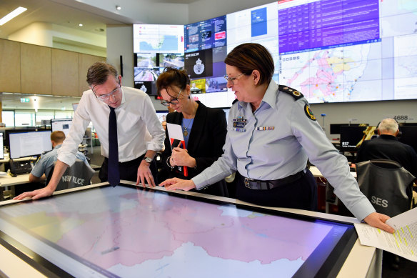 Premier Dominic Perrottet, NSW Minister for Emergency Services and Resilience and Minister for Flood Recovery Steph Cooke, and NSW SES Commissioner Carlene York look over current flood zone maps earlier this week.