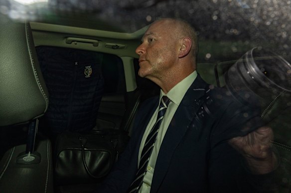 Catholic Schools NSW chief executive Dallas McInerney is chaperoned from the ICAC after giving evidence on Thursday.