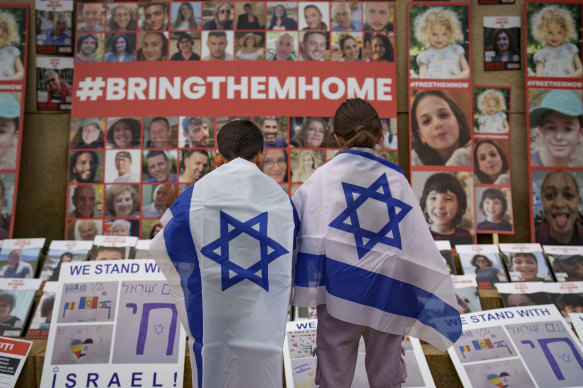 Children look at photographs of Israelis kidnapped by Hamas.