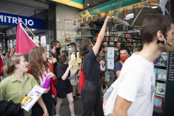 Protesters marching past the Better Read than Dead store in Newtown.