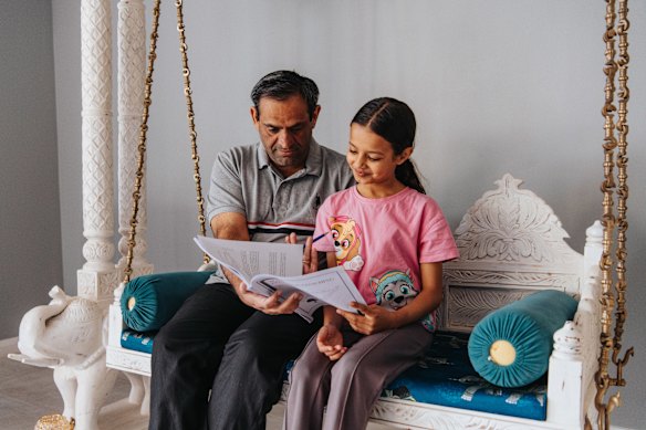Tapan Kotecha looks at the results of the opportunity class tests with daughter Veera, 9.