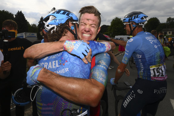 Stage winner Simon Clarke is congratulated by a teammate.