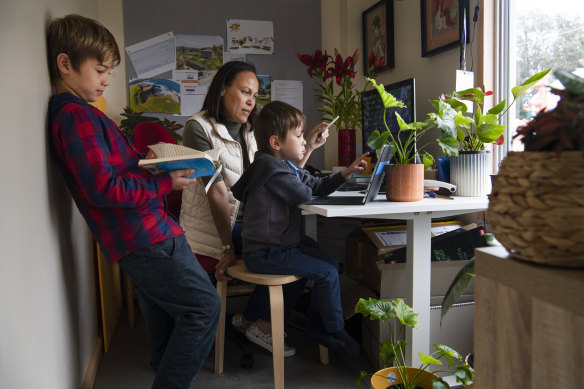 Dee Mills helping her sons, Jaxon, 9, and Harrison, 5, with their school work in their Matraville home.