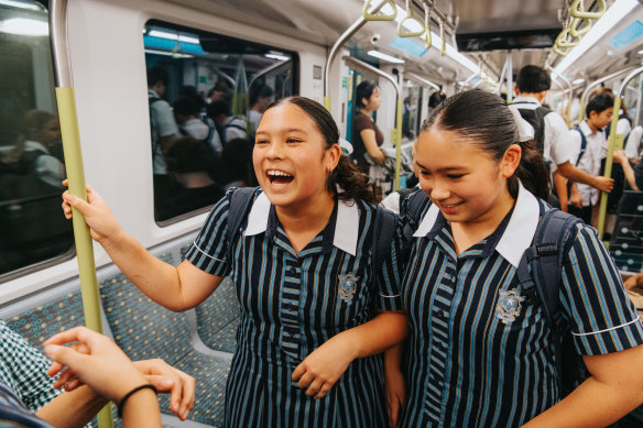 Elly and Imogen Wagener enjoy the ride to school on the metro, thanks to their parents’ foresight. 
