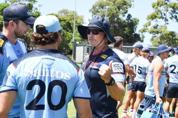 Waratahs coach Darren Coleman talks to his players at training.