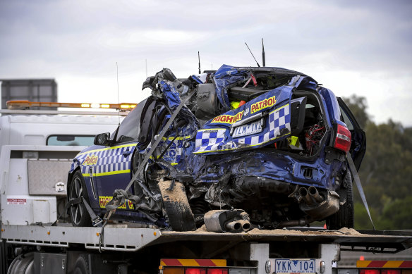 One of the police cars being removed from the crash scene.