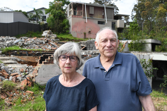 Susan Magnay and Philip Bull in front of the ruins of their home in Malua Bay.