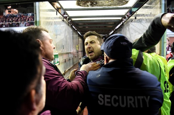 Security and police swooped on a Manly fan, centre, who confronted Melbourne Storm’s Will Chambers.