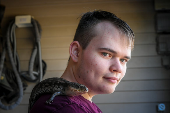 Flynn Spencer with his pet blue tongue lizard.