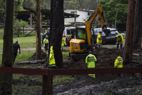 Police searching a piece of land on Monday. 