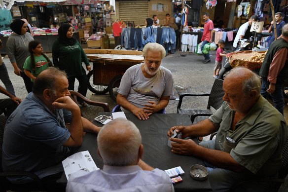 From left: Abdul Hadi Zakari, Mohammed, Raid Jammal  and Mohammed play cards at a cafe outside Shatila Palestinian refugee camp in Beirut.