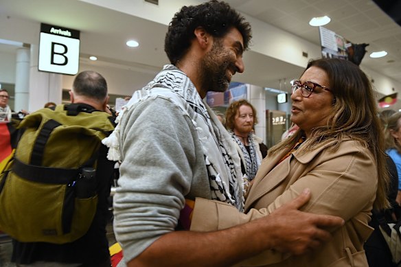 Seven of the 11 flotilla participants, including Surya McEwen (pictured here embracing Greens Senator Mehreen Faruqi), were given a hero’s welcome at Sydney Airport on Monday.