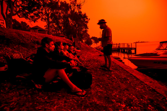 Day turns to blood red night in Mallacoota on Saturday as families wait for relief.