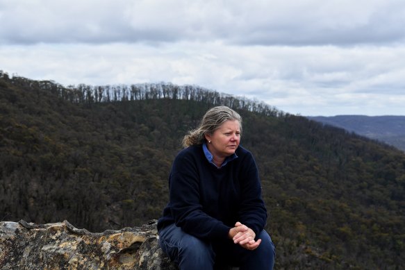 Mount Wilson RFS captain Beth Raines at Du Faurs Rocks lookout, with bushland in the background that was affected by the Mount Wilson backburn during the 2019/2020 bushfires. 