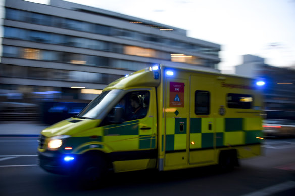 An ambulance drives past St Thomas’ Hospital in central London.