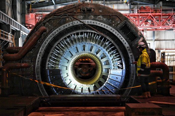 A demolition worker examines a Siemens turbine within the main power plant at Wallerawang.