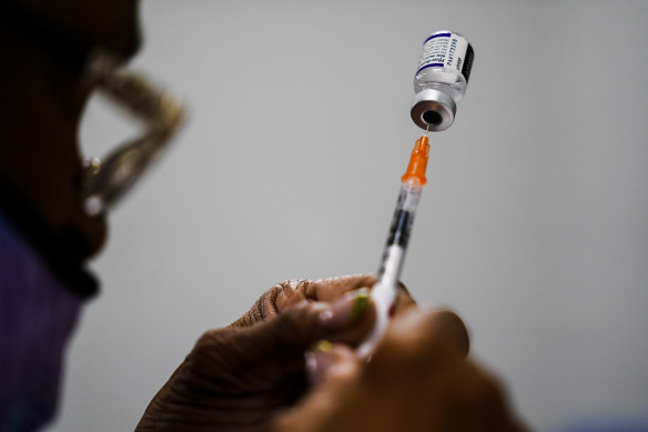 A syringe is prepared with the Pfizer COVID-19 vaccine at a vaccination clinic in Chester, Pennsylvania.