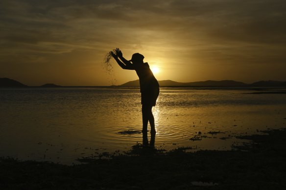 Donniella Warria aged 9 years old plays on the Bach Beach as the sun sets on Thursday Island.