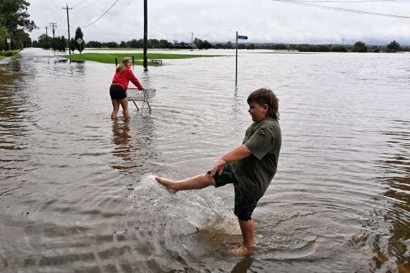 Megan and Mitchell Shultz from Pitt Town playing in water on the edge of Windsor.