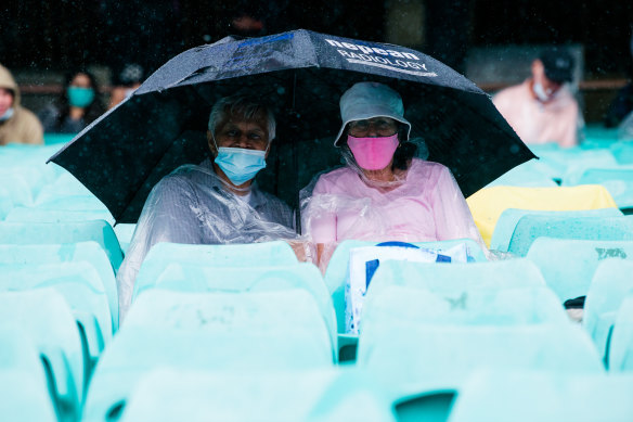 Margaret and Joe Mistry, from Blakehurst, defy the elements at the SCG.