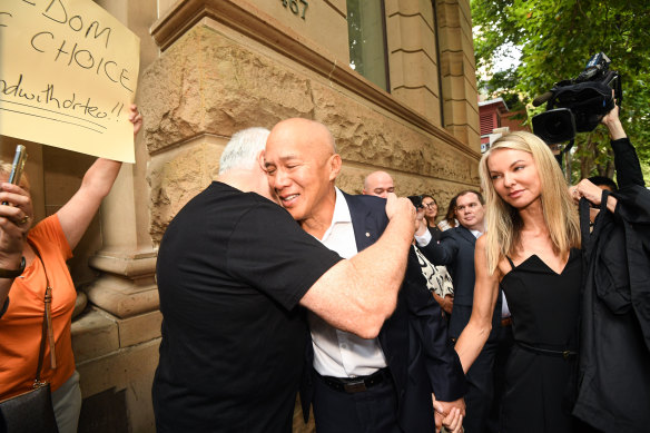 Charlie Teo is greeted by supporters outside the hearing.