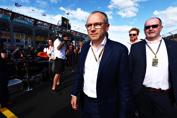 Formula 1 chief executive Stefano Domenicali (centre) walks on the grid during the Australian Grand Prix in 2022.