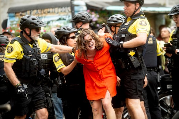 Police officers detain a protester against right-wing demonstrators in Portland.