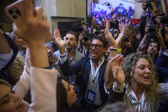 Fratelli d’Italia (Brothers of Italy) supporters celebrate after Giorgia Meloni’s appearance at the party headquarters in Rome. 