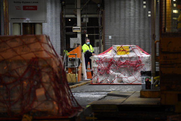 A pallet of Pfizer vaccines is unloaded at the Qantas freight terminal.