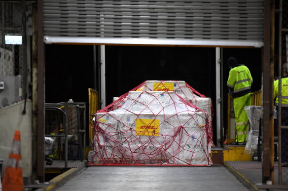 A pallet of Pfizer vaccines is unloaded at the Qantas freight terminal after landing on Qantas flight QF10 from London at Kingsford Smith International Airport.
