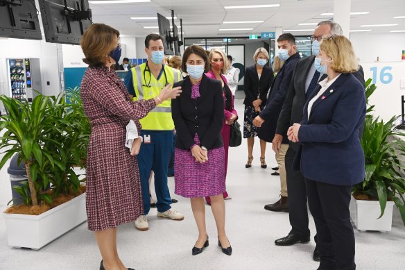 Gladys Berejiklian and Brad Hazzard visit the Olympic Park vaccination hub on Monday. 