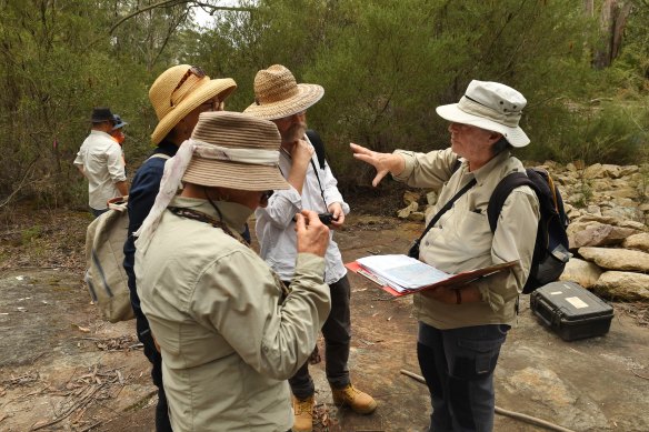 Julie Sheppard (right), a member of the National Parks Association, explains to other conservationists where the mine impacts are showing up at the surface.