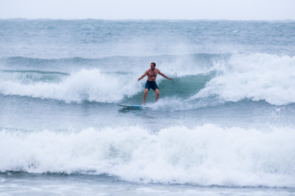 Member for Pittwater Rob Stokes surfing at Collaroy Beach on Monday.