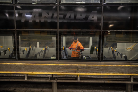 A cleaner on a Tangara train at the Mortdale depot. 