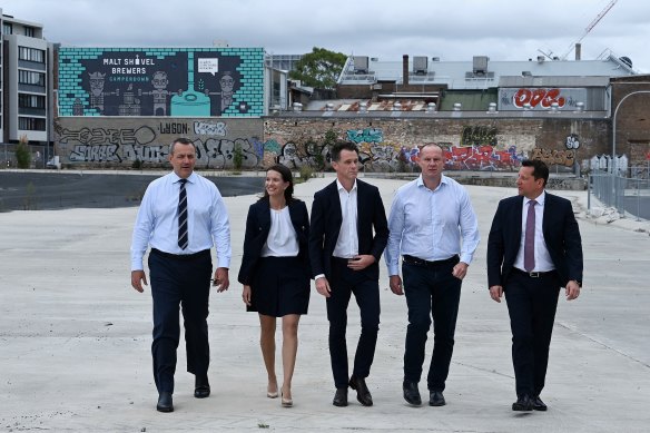 NSW Premier Chris Minns (centre) addressed the media from an Annandale build-to-rent site.