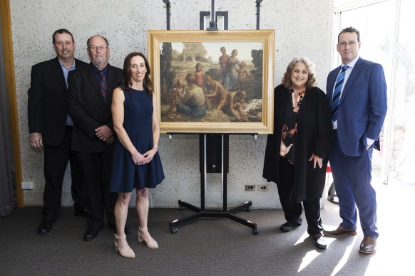 Members of the Nickl family with the 1944 painting Bush walkers. The family has donated the painting to the National Gallery of Australia.