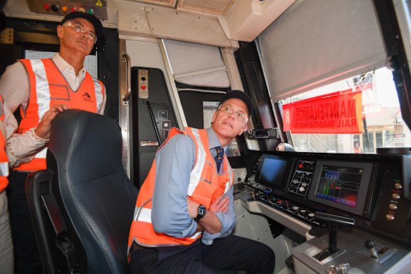 Premier Chris Minns (right) and Transport Minister John Graham in the driver’s cabin of a refurbished Tangara passenger train last year.