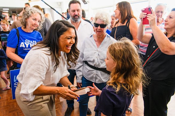 The senator signs a copy of her book for a young girl at the Mount Pleasant Bowling Club. She told the crowd education should replace indoctrination in the curriculum.