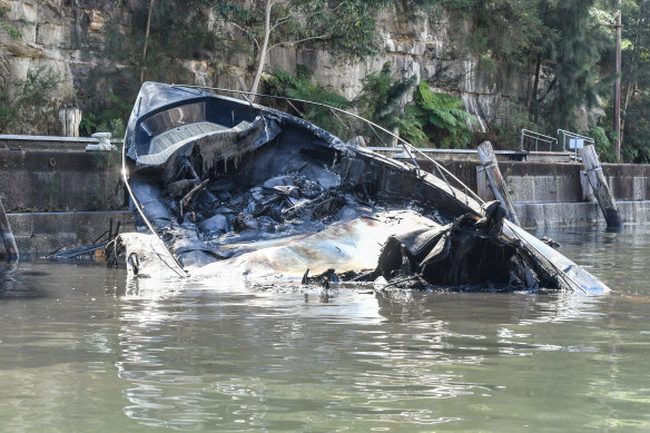 The destroyed luxury yacht was largely submerged on Sunday morning.