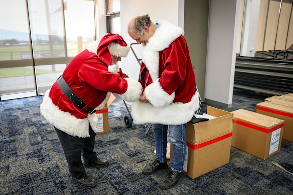 Trying on the role: A student receiving his Santa suit at the seminar in Springvale on Thursday.
