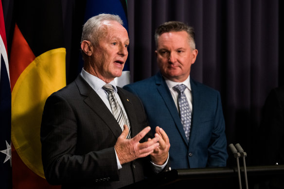 Chris Bowen listens to Greg Mullins at a press conference on Thursday.