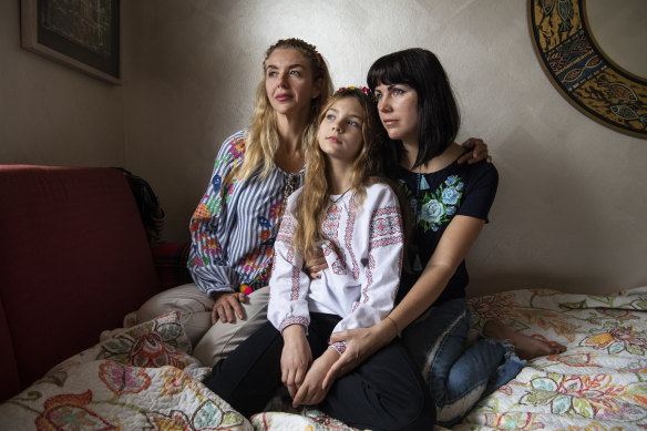 Mariia Ruban (right) with her 8-year old daughter Margo and her sister Vita. Mother and daughter arrived in Sydney last week after leaving Mariupol with little more than the clothes on their backs.