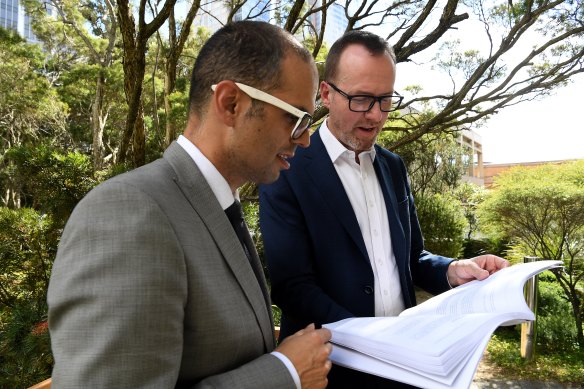 Daniel Mookhey (left) and Greens MP David Shoebridge read an upper house committee report into icare.
