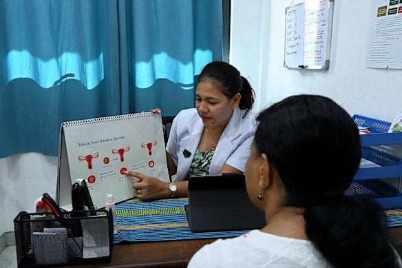 Dr Maria Jose consults with Luisa before she self-tests for the human papillomavirus (HPV) at the Vera Cruz Community Health Centre in Dili.